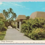Historic photograph of the Punaluʻu Village Restaurant surrounded by tropical landscaping on the Kaʻū coast of Hawaii