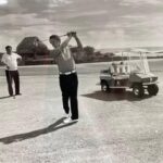 Historic photograph of golfers playing at Sea Mountain Golf Course in Punaluʻu, Hawaiʻi, with clubhouse and golf cart visible, early 1970s